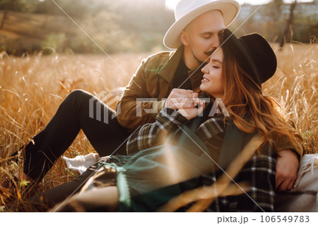 Lovely hipster couple resting in nature. People, lifestyle, relaxation and vacations concept. Lovely hipster couple resting in nature. People, lifestyle, relaxation and vacations concept. 106549783