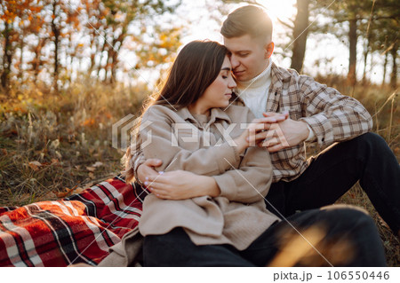 Couple having fun walking, hugging on autumn park at sunset. People, lifestyle, relaxation concept. Couple having fun walking, hugging on autumn park at sunset. People, lifestyle, relaxation concept. 106550446