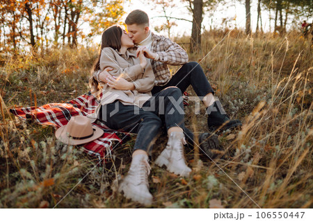 Couple having fun walking, hugging on autumn park at sunset. People, lifestyle, relaxation concept. Couple having fun walking, hugging on autumn park at sunset. People, lifestyle, relaxation concept. 106550447
