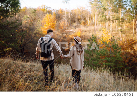 Couple having fun walking, hugging on autumn park at sunset. People, lifestyle, relaxation concept. Couple having fun walking, hugging on autumn park at sunset. People, lifestyle, relaxation concept. 106550451