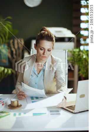 woman worker in light business suit in green office woman worker in light business suit in green office 106551055