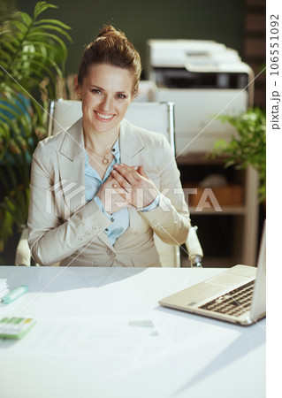 happy woman worker in light business suit in green office happy woman worker in light business suit in green office 106551092