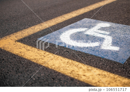 Parking sign for disabled on asphalt with yellow lines 106551717
