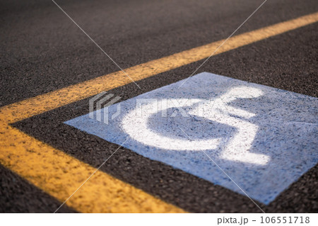 Parking sign for disabled on asphalt with yellow lines 106551718