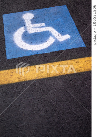 Parking sign for disabled on asphalt with yellow lines 106551806