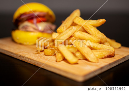 Yellow Mini Gourmet Burger with French Fries on wooden board 106551942