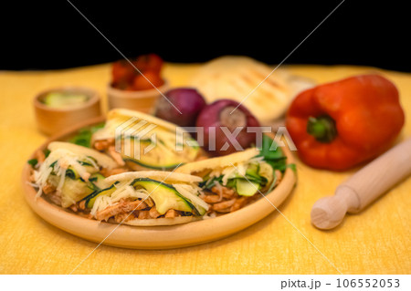 Traditional Arepas originating in Latin America, tasty stuffed corn dough 106552053