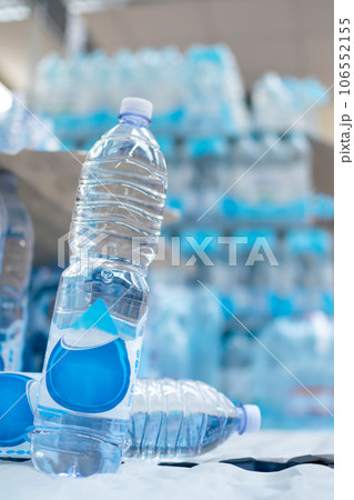 Water bottles stored on supermarket shelves for sale and consumption Water bottles stored on supermarket shelves for sale and consumption 106552155