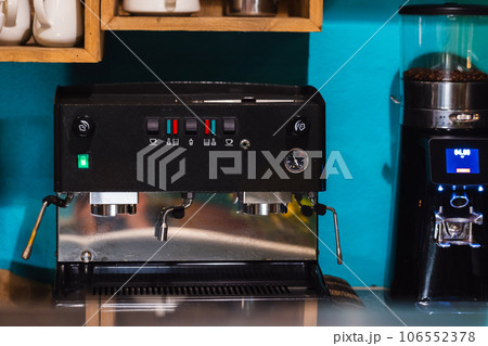 Professional coffee machine and grinder stand in a restaurant Professional coffee machine and grinder stand in a restaurant 106552378