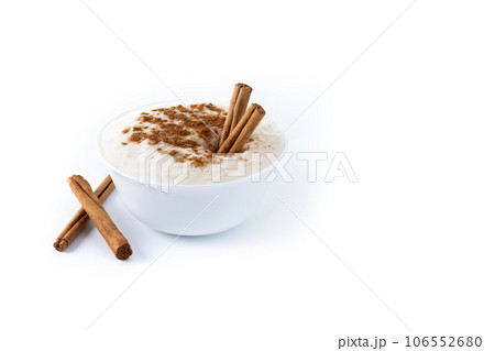 Arroz con leche. Rice pudding with cinnamon in white bowl isoalted on white background 106552680