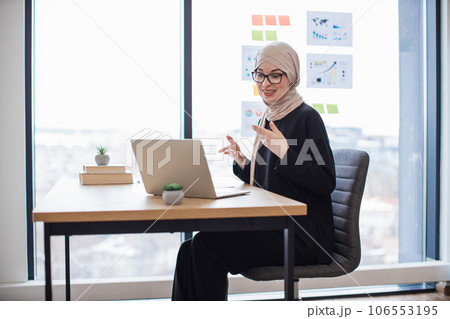Female manager having online discussion via webcam in office Female manager having online discussion via webcam in office 106553195