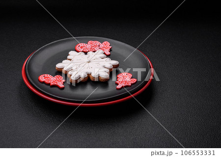 A beautiful Christmas composition consisting of ceramic plates, gingerbread and other elements A beautiful Christmas composition consisting of ceramic plates, gingerbread and other elements 106553331