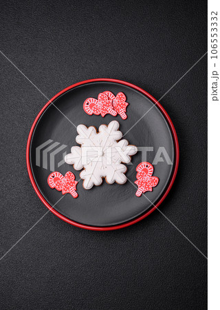 A beautiful Christmas composition consisting of ceramic plates, gingerbread and other elements A beautiful Christmas composition consisting of ceramic plates, gingerbread and other elements 106553332