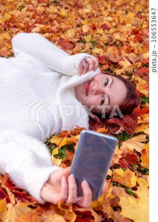 Woman taking selfie in an autumn scenery 106553647