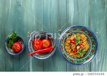 Uzbek pilaf on a wooden board. Long banner format. top view 106554289