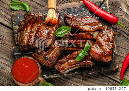 Delicious barbecued ribs seasoned with a spicy sauce. place for text, top view Delicious barbecued ribs seasoned with a spicy sauce. place for text, top view 106554297