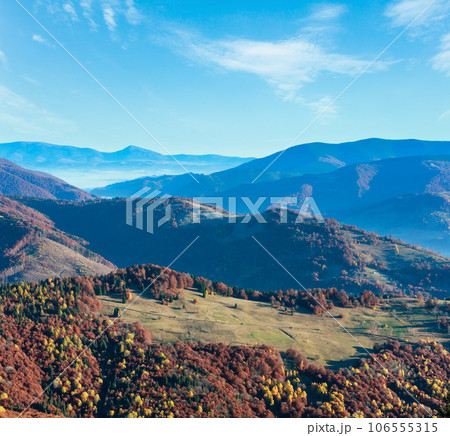 Morning fog in autumn Carpathian mountains and colorful forest on slope. Ukraine. Morning fog in autumn Carpathian mountains and colorful forest on slope. Ukraine. 106555315