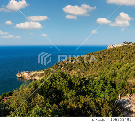 Summer sea perched Peschici town and cape Trabucco di Monte Pucci view, Gargano peninsula in Puglia, Italy 106555493