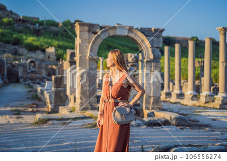 Pretty tourist woman at the ruins of ancient city of Perge near Antalya Turkey Pretty tourist woman at the ruins of ancient city of Perge near Antalya Turkey 106556274