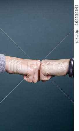 two people greeting each other with knuckles two people greeting each other with knuckles 106556643