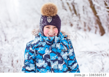 boy throwing snow in the air at sunny winter day, back view 106560537
