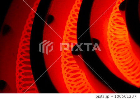 真っ赤に加熱した電熱線(コイルニクロム線)・レトロな電気コンロの五徳部分接写写真 真っ赤に加熱した電熱線(コイルニクロム線)・レトロな電気コンロの五徳部分接写写真 106561237
