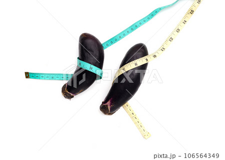 Eggplant with measuring tape on white background. Eggplant with measuring tape on white background. 106564349