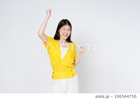 Young asian woman with raised hands celebrating success isolated on white background. 106564750