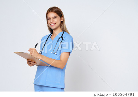 Portrait of smiling woman doctor taking notes making medical with clipboard isolate over white background. 106564791