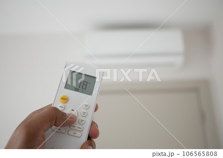 Close up of man hand holding air condition remote. 106565808