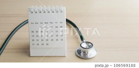 Stethoscope with calendar page date on wood table background doctor appointment medical concept Stethoscope with calendar page date on wood table background doctor appointment medical concept 106569188
