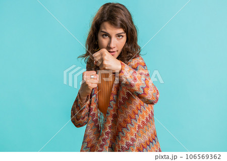 Aggressive young woman trying to fight at camera, shaking fist, boxing with expression, punishment 106569362