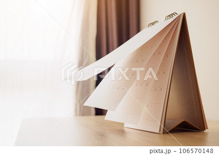 Calendar page flipping sheet on wood table background business schedule planning appointment meeting concept 106570148