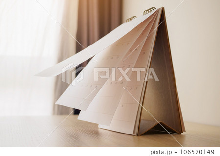 Calendar page flipping sheet on wood table background business schedule planning appointment meeting concept 106570149
