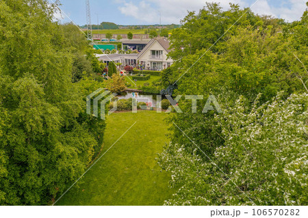 an aerial view of the house from above, with trees and bushes in the fore - image is taken from drone an aerial view of the house from above, with trees and bushes in the fore - image is taken from drone 106570282