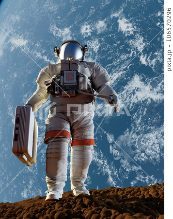 Astronaut with a suitcase walking on the planet 106570296