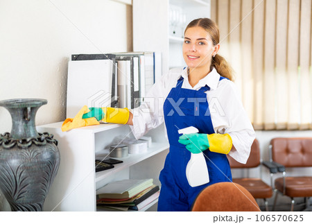 Charwoman cleaning office 106570625