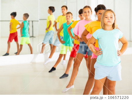 Children primary school age rehearsing movements of ballet dance in modern studio Children primary school age rehearsing movements of ballet dance in modern studio 106571220
