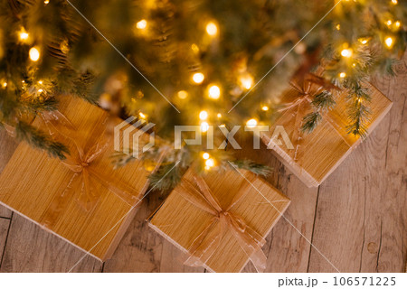 Gift boxes near decorated christmas tree Gift boxes near decorated christmas tree 106571225
