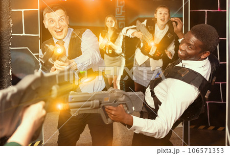 men and women co-workers having corporate entertainment 106571353