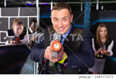 Man holding laser gun and playing laser tag 106571473