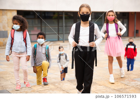 Tweenager girl in protective mask going to school lessons Tweenager girl in protective mask going to school lessons 106571593