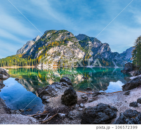 Autumn peaceful alpine lake Braies or Pragser Wildsee. Fanes-Sennes-Prags national park, South Tyrol, Dolomites Alps, Italy, Europe. Picturesque traveling, seasonal and nature beauty concept scene. Autumn peaceful alpine lake Braies or Pragser Wildsee. Fanes-Sennes-Prags national park, South Tyrol, Dolomites Alps, Italy, Europe. Picturesque traveling, seasonal and nature beauty concept scene. 106572399