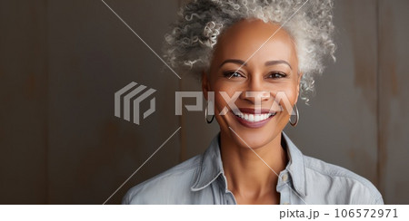 Middle-aged woman with a short gray hair looking at camera. 106572971