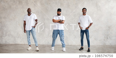 Collage of three different men full body against textured gray wall, dressed in jeans and white T-shirts. Serious guys, fashion models Collage of three different men full body against textured gray wall, dressed in jeans and white T-shirts. Serious guys, fashion models 106574750
