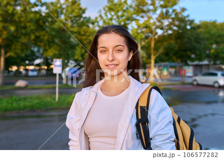 Outdoor portrait smiling high school student girl with backpack Outdoor portrait smiling high school student girl with backpack 106577282