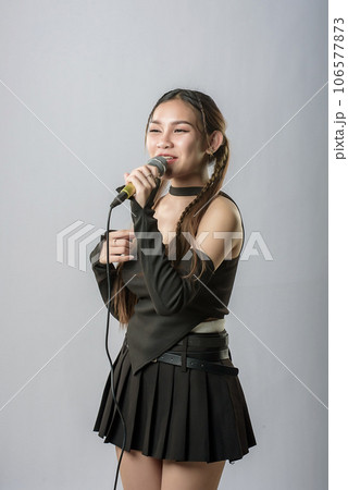 young beautiful asian woman with headphones 106577873