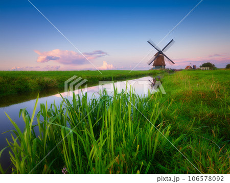 An old mill in the Netherlands. Historical building. A mill near a canal. An old mill in the Netherlands. Historical building. A mill near a canal. 106578092