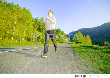 Man jogging in city partk at beautiful summer day. Sport fitness model caucasian ethnicity training outdoor. 106578662