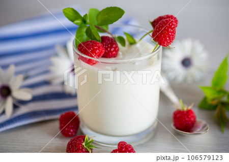 Sweet cooked homemade yogurt with fresh raspberries in a glass. Sweet cooked homemade yogurt with fresh raspberries in a glass. 106579123